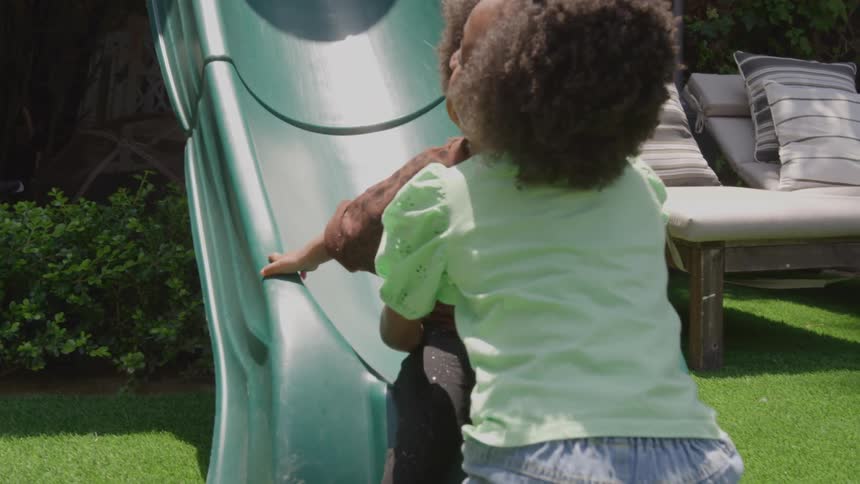 The girl catches another girl coming down the slide