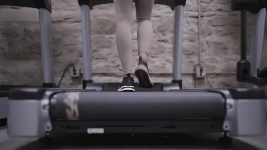 Woman exercising walking on a treadmill