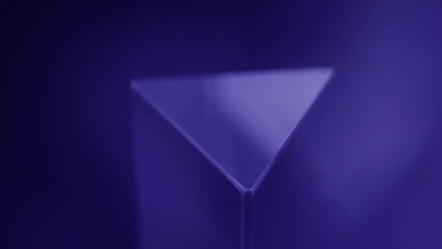 Triangular top of a crystal reflects the light in a blue area