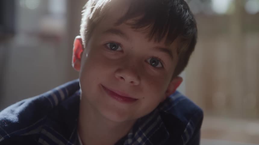 Boy in a plaid shirt looking