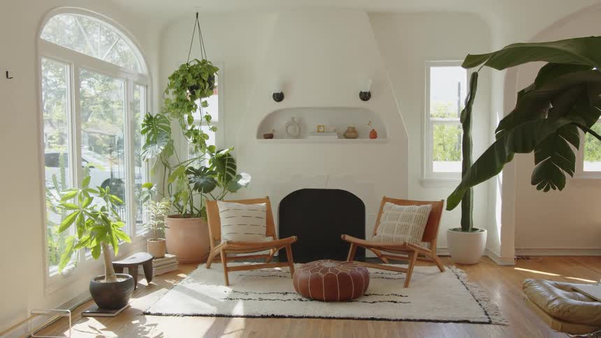 Two chairs are by the chimney in the living room
