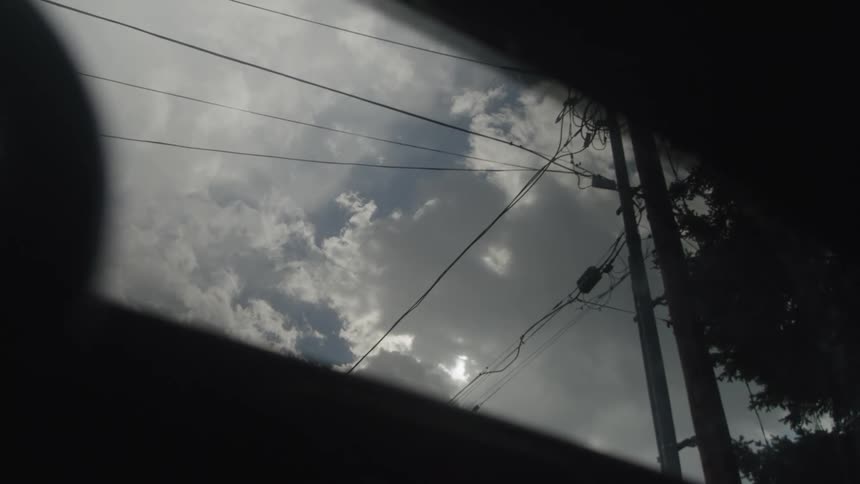 A pair of operating windshield wipers in a stationary vehicle during a rainy day