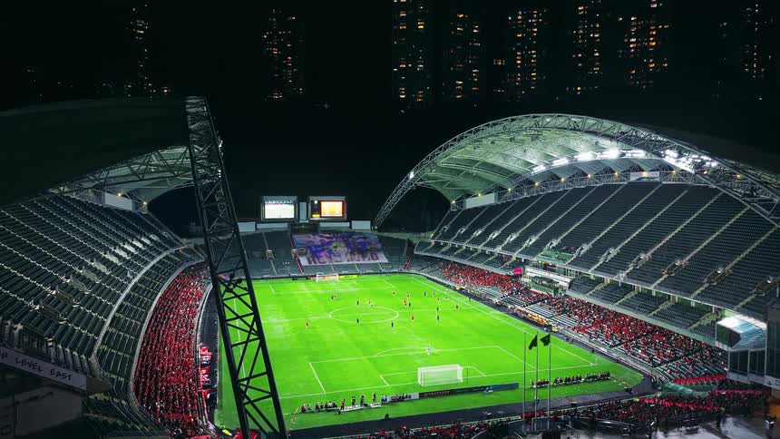 Crowd of people in the stadium watching the soccer game on the field