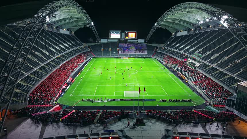 The people walk around the stadium during a soccer game