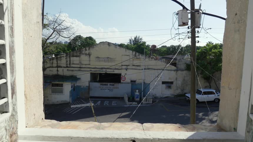 A large building across the street through an open window