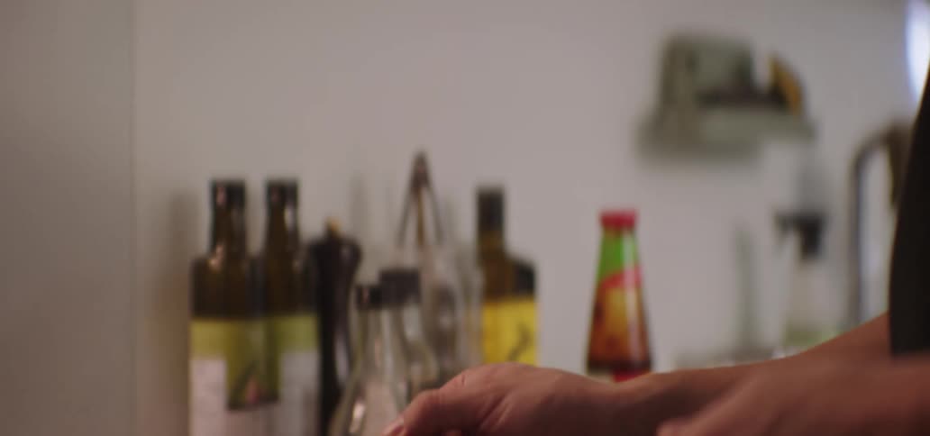 Man cooking in a frying pan and tasting the food