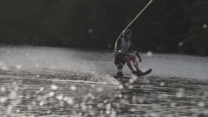 A man water skis on a lake