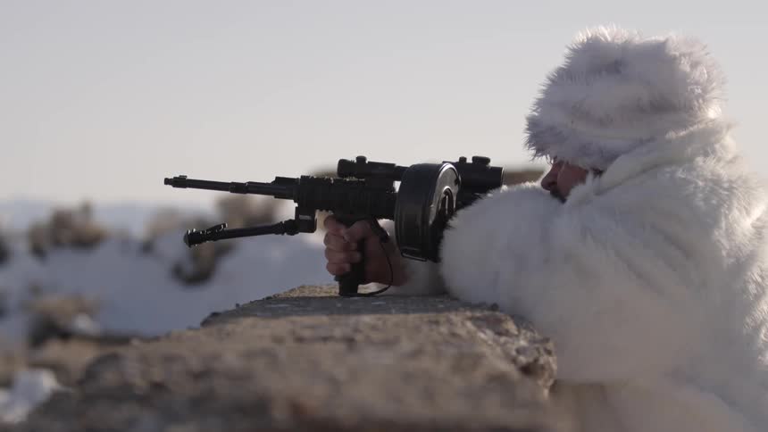 A person is firing a machine gun
