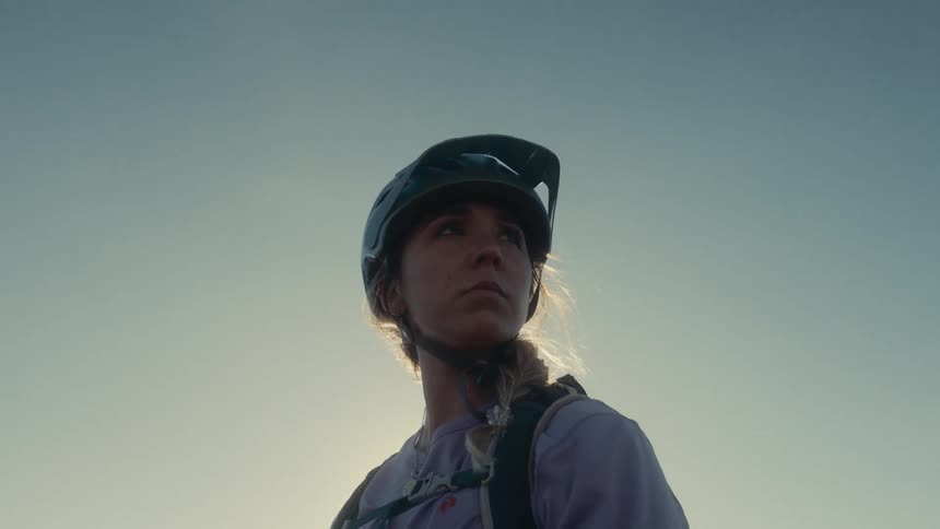 Cyclist looking toward the horizon under a clear sky