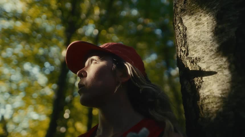 A woman standing outside by a tree