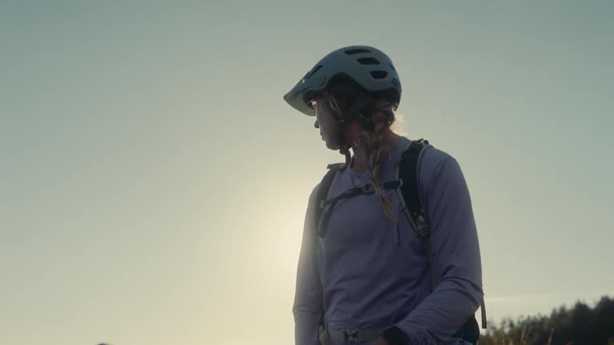 A portrait of a woman wearing a helmet outdoors