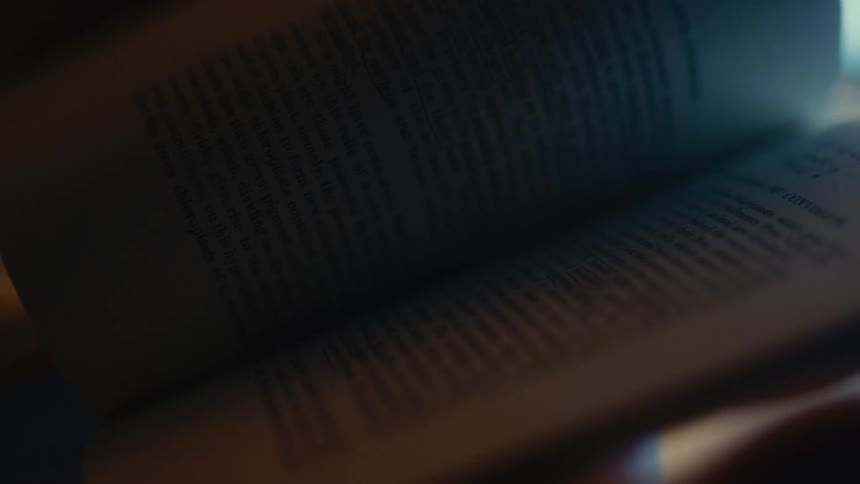 A person turning pages in a book