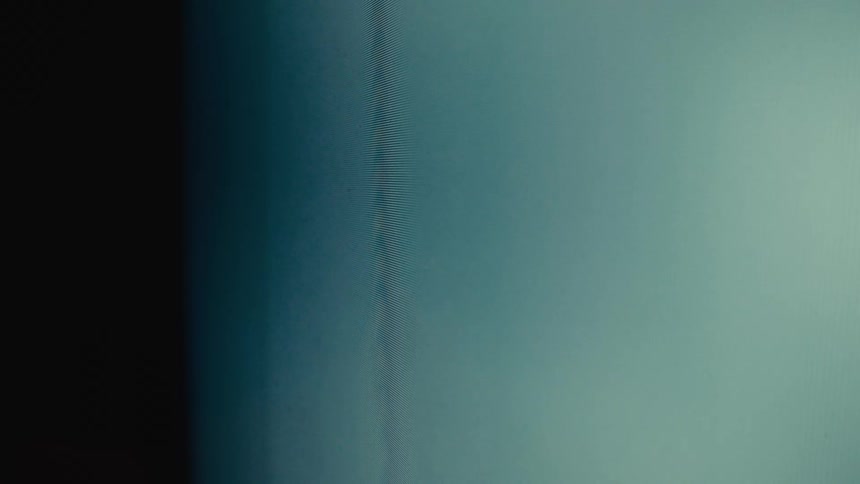Bluegreen screen with a dark vertical line in the center