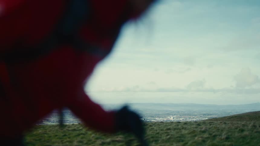 Blurred figure walking with poles in an open field