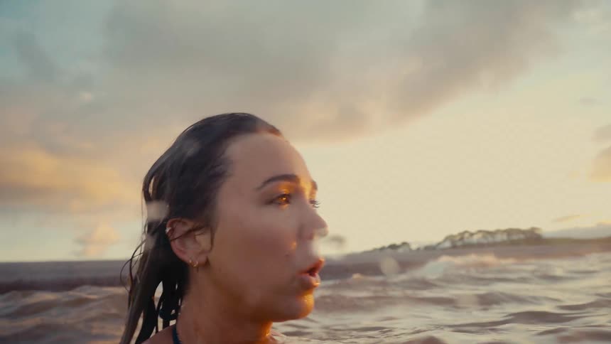 Woman submerged to her shoulders swimming at s