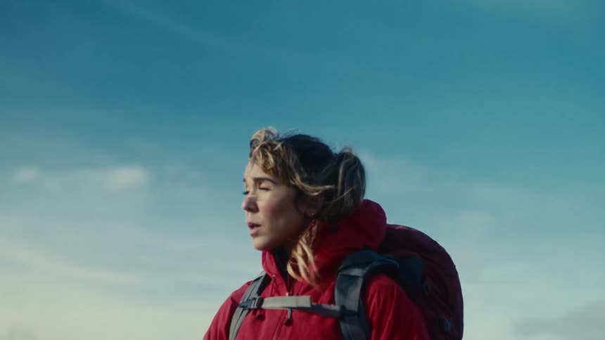 A woman standing outdoors in a jacket