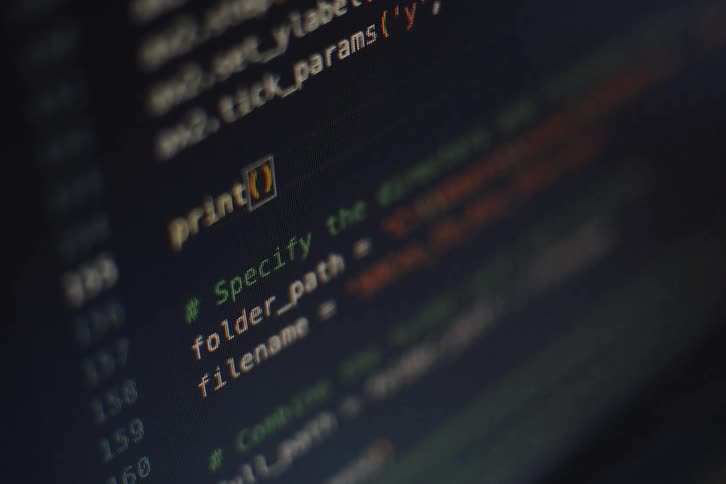Software code changes on the computer screen while a person programs