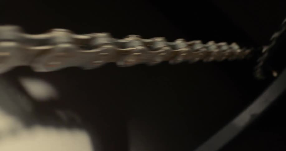 A bicycle chain spinning quickly on its wheel