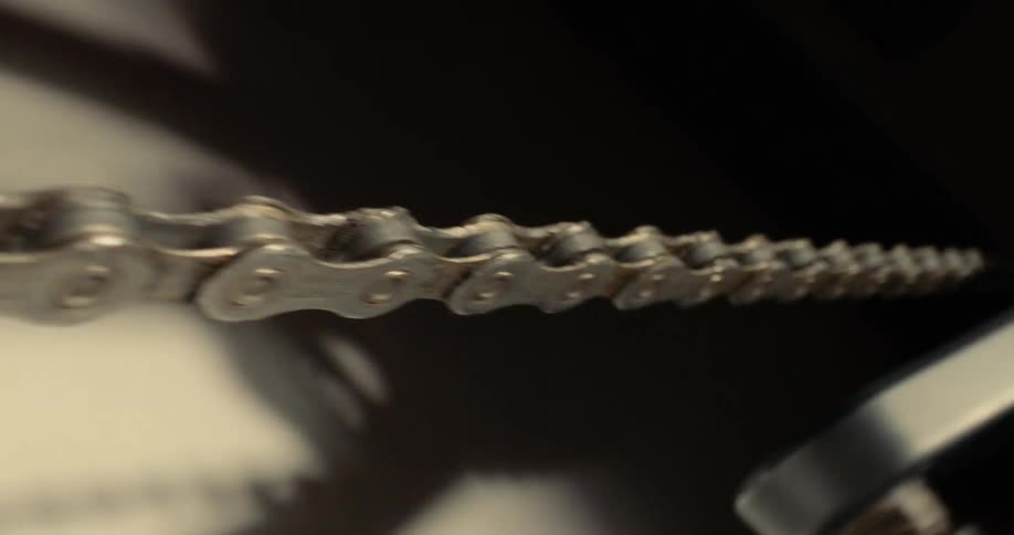 Close up of a bicycle roller chain in motion
