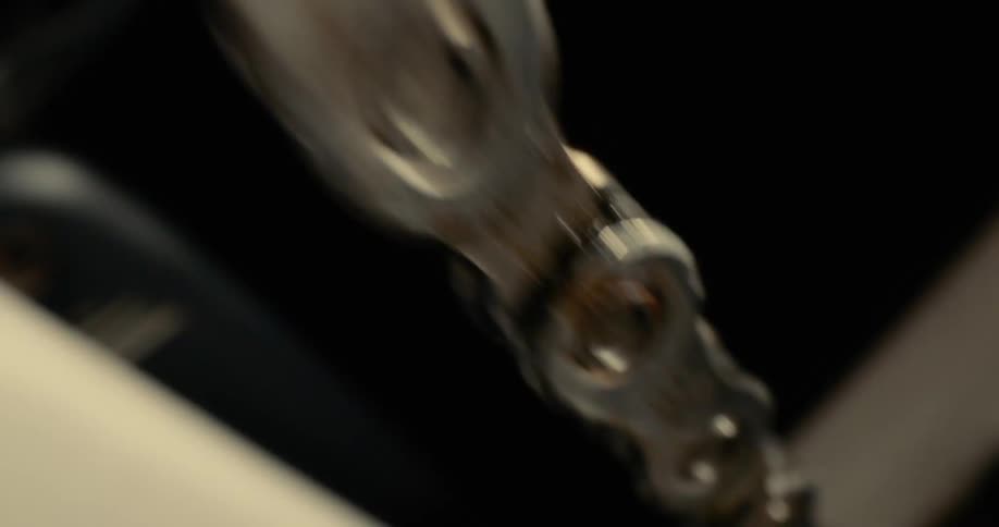 A bicycle chain spinning quickly on its wheel