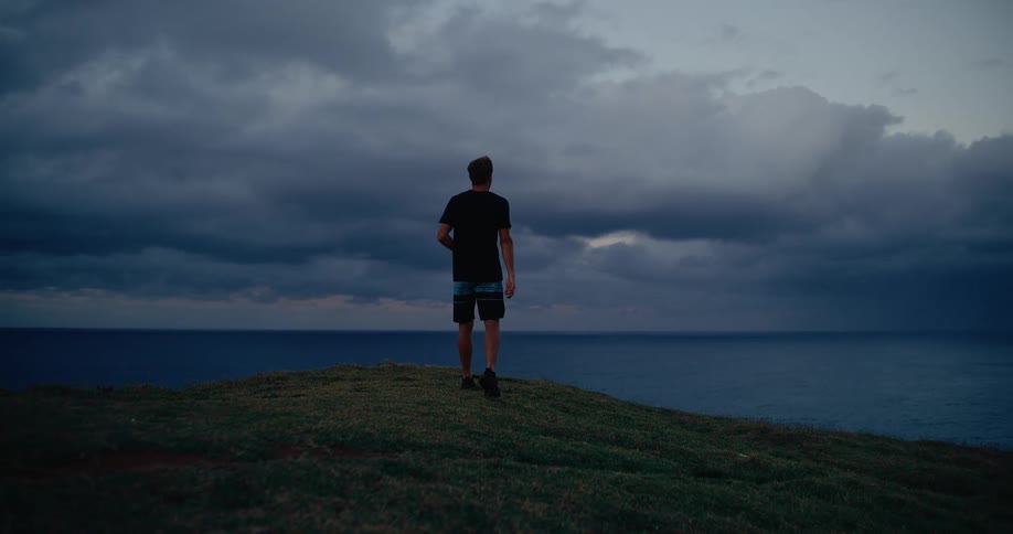 Man walking in a coastal area with the sea in the background