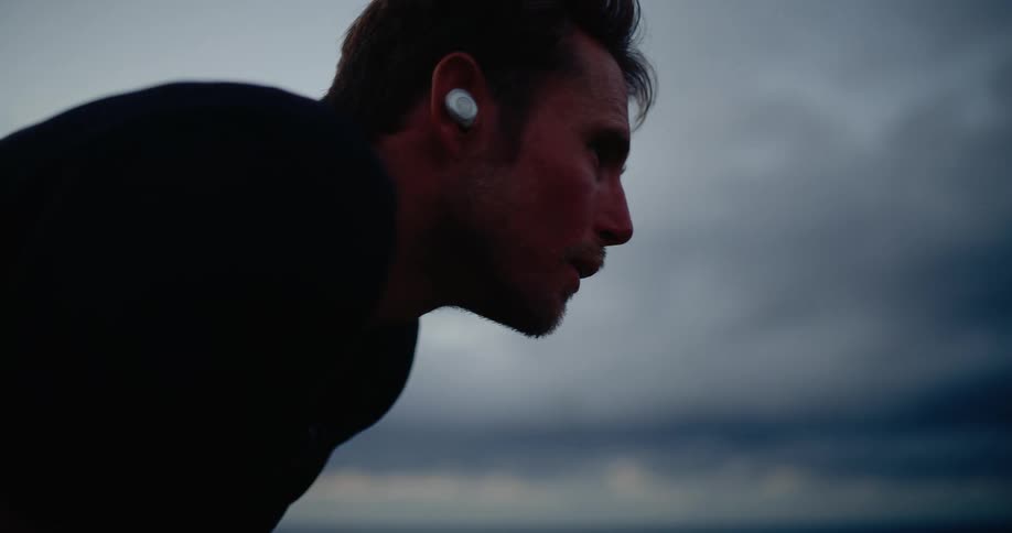 Close up of a man in a standing tripod position outdoors during a fitness session in daytime