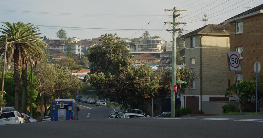 The bus speeds down the road in town