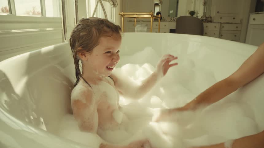 A mother giving her daughter a bath