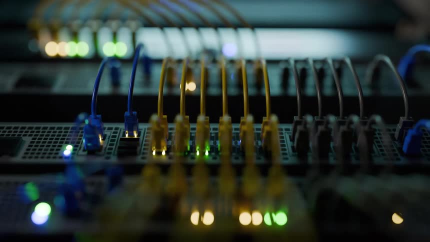 Network cables connected to equipment with green blue and yellow indicator lights