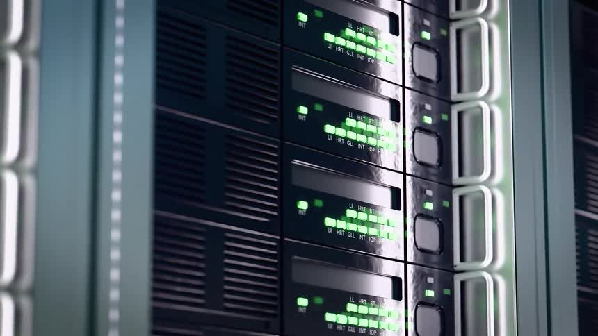The video shows a closeup panning view of multiple networked server racks in a data center with rows of blinking indicator lights the lights mostly flash green occasionally switching to red or blue suggesting data transfer and system activity