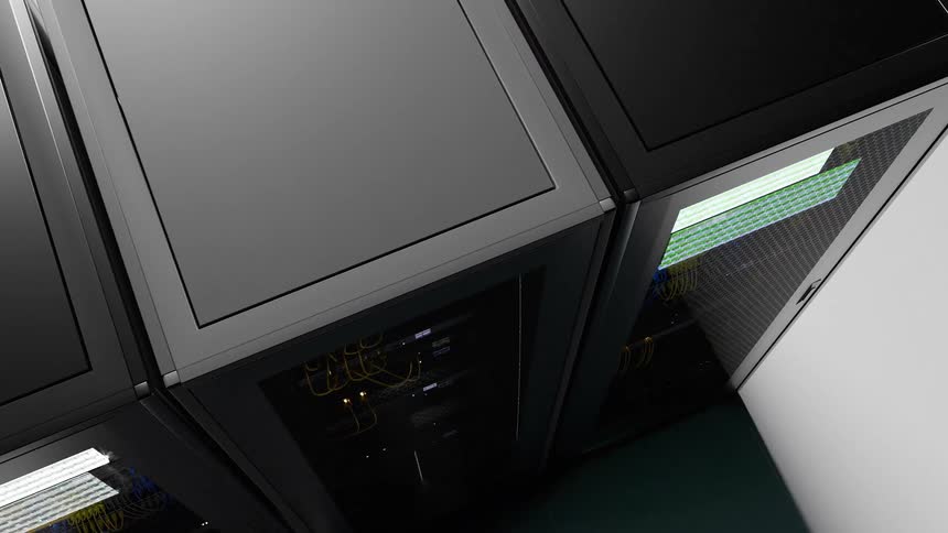 A small room with a few black computer processors with active lights in a bright room