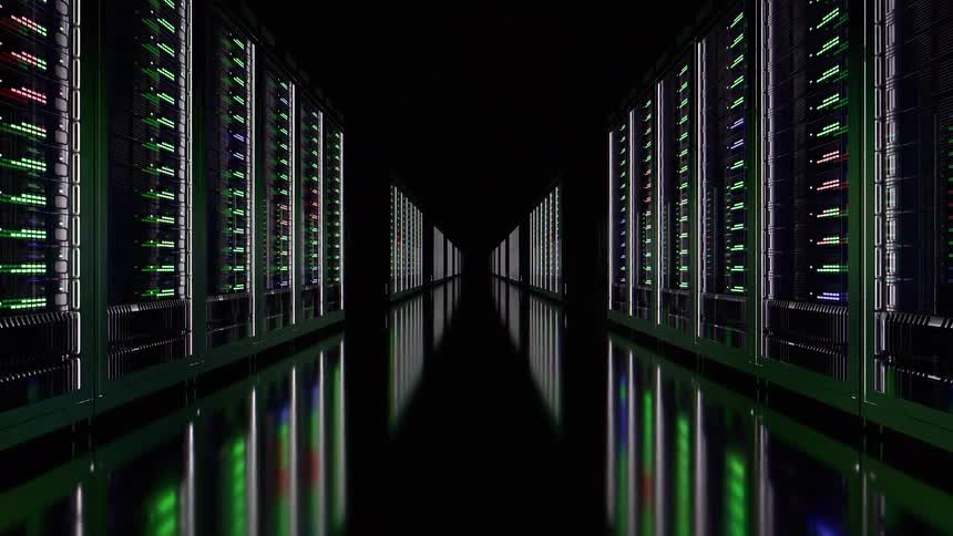 Server corridor with rows illuminated by green red and blue leds reflected on the dark floor