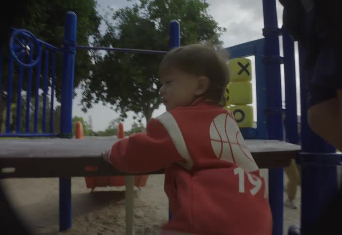Children climbing on an outdoor playground structure