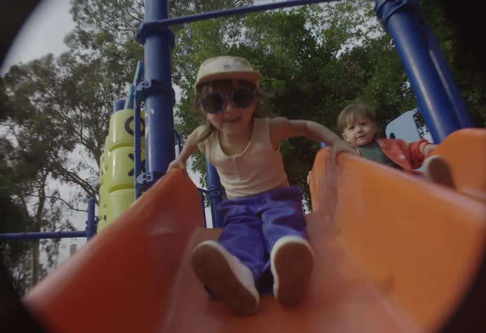 Children playing on a slide in a playground