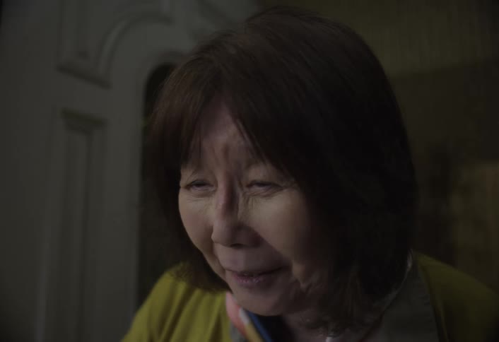 Elderly woman talking on the phone indoors