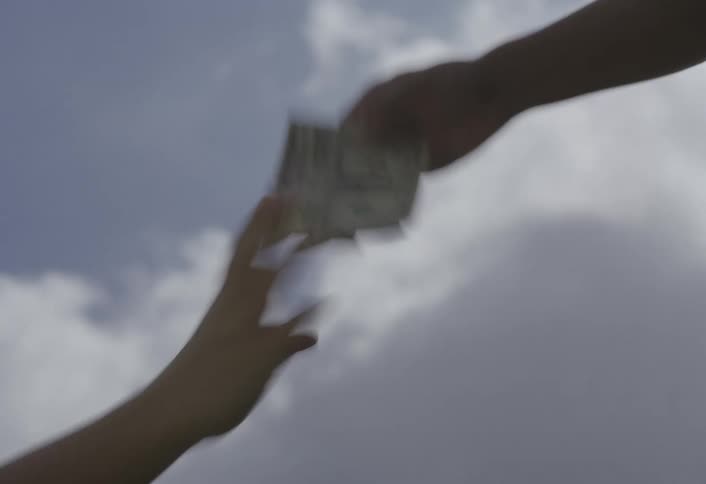 Cash is waved then handed to someone