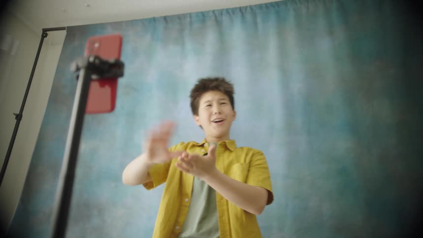 A young male poses for the camera while acting very silly