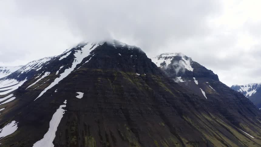 The tall mountains have snow at the peak