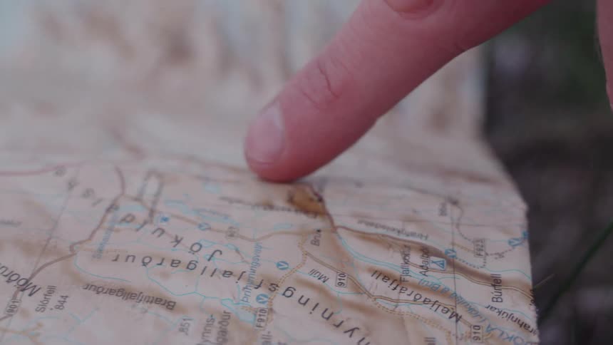 A person following lines on a map