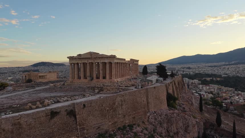 Parthenon viewed from above with athens in the background at dusk