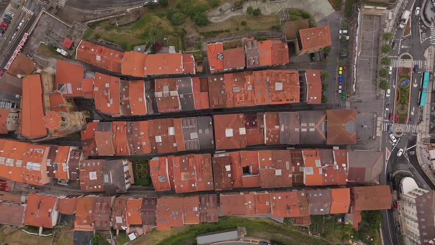 Suburban neighborhood with a waterfront to one side and roads and streets to the other outdoors during day time