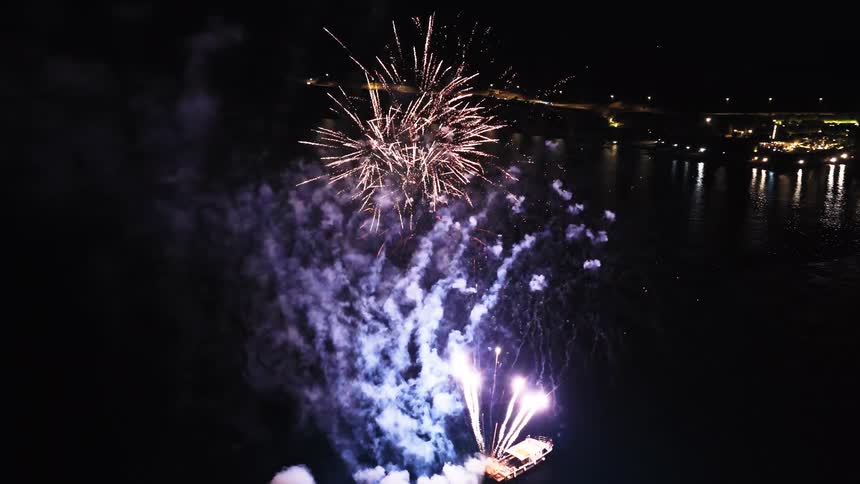 Fireworks lighting up the night sky above the water
