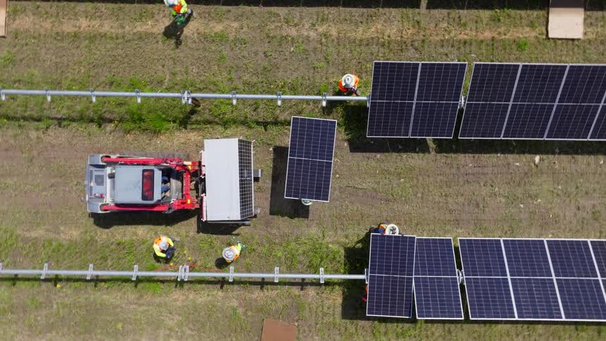 A group of workers setting up solar panels