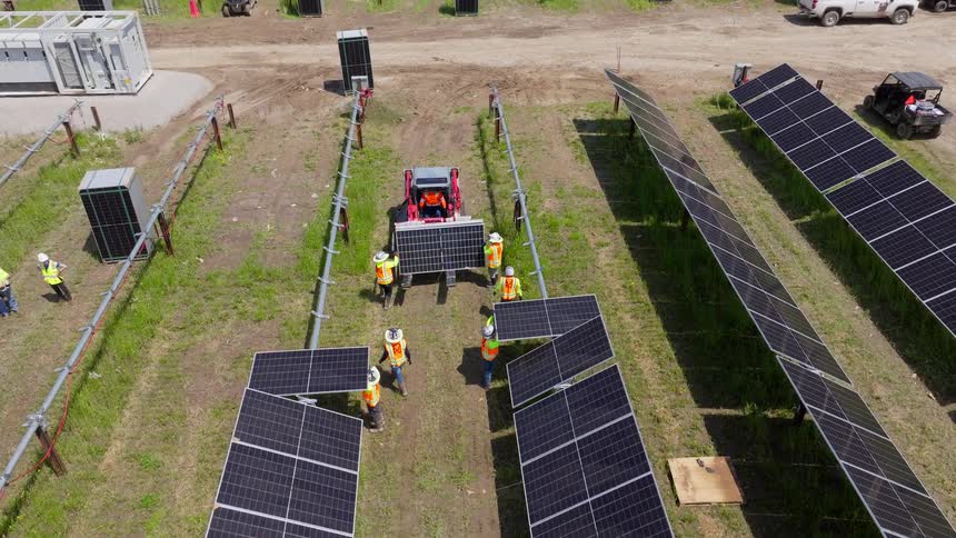 Workers are installing solar panels on the farm