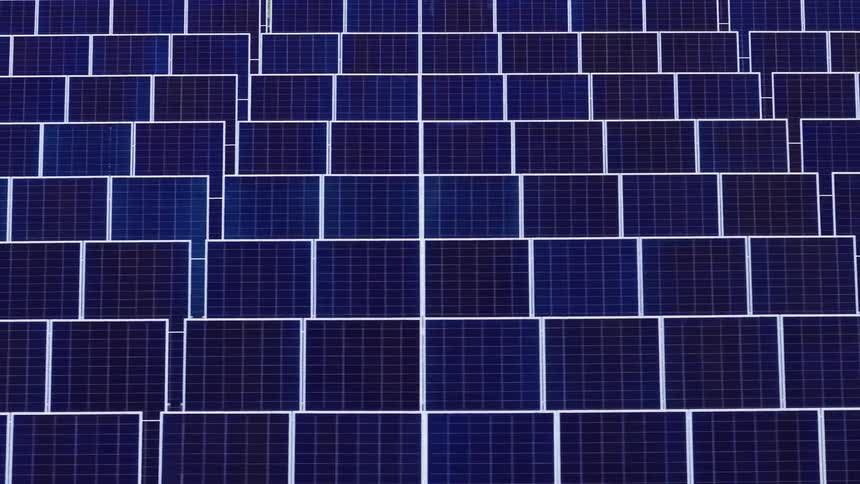 Solar panels arranged in grid pattern with photovoltaic cells on metal structure
