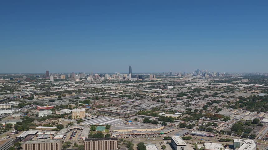 The sequence begins with an aerial shot of a sprawling dense city landscape under a clear blue sky it transitions to workers installing solar panels outdoors followed by a final shot of a brightly lit futuristic data center aisle filled with rows of g