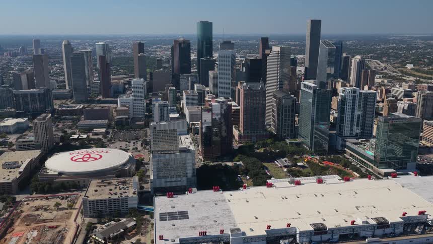 Towers and skyscrapers on the metropolitan skyline as traffic moves on the highway