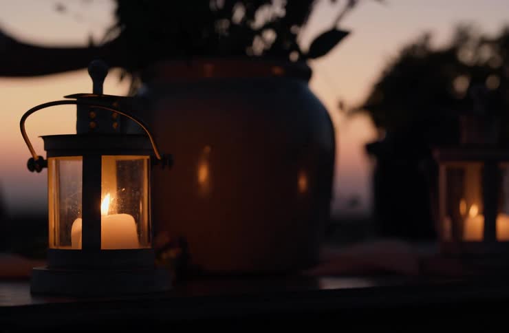 A view of some candles outdoors at dusk