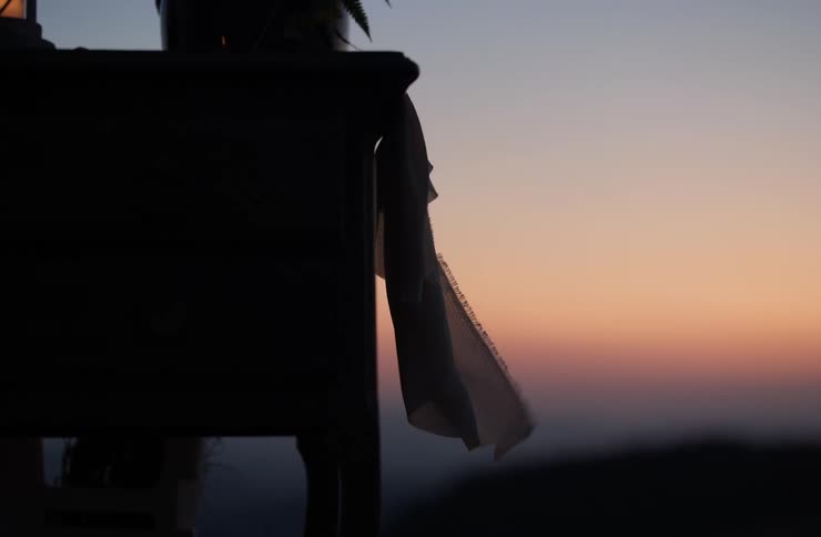 Cloth hanging from the table in front of the sunset
