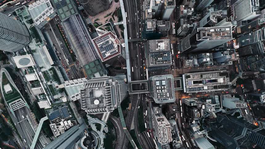 Densely built urban center seen from above with roads walkways and skyscrapers
